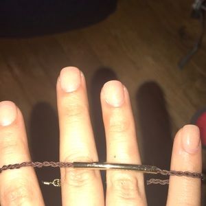 Bracelet with long gold charm and brown strap